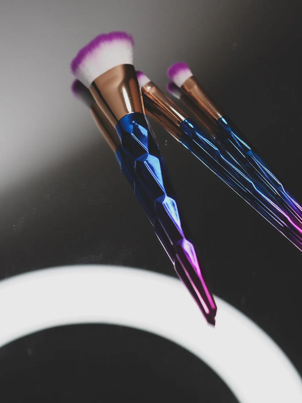 Makeup brushes arranged on a reflective surface